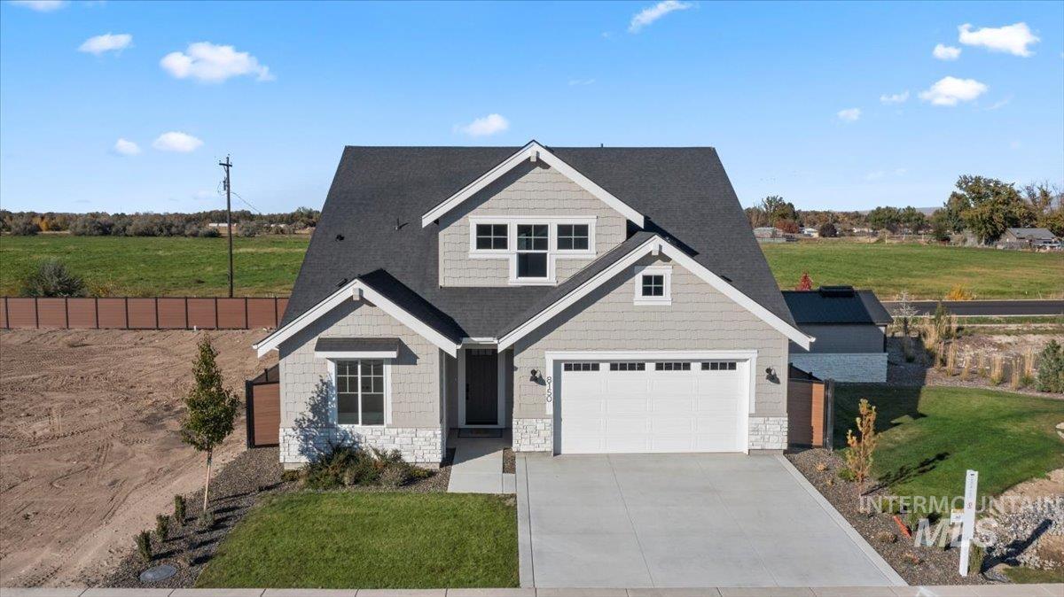 Craftsman house with concrete driveway and stone siding