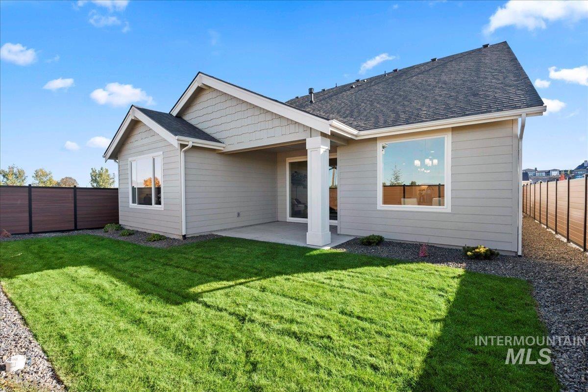 Back of house with a patio, a fenced backyard, and roof with shingles