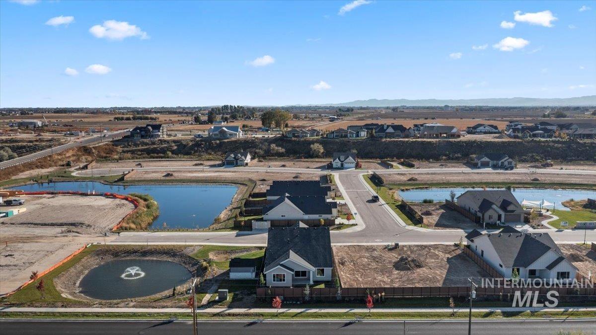 Aerial perspective of suburban area featuring a large body of water