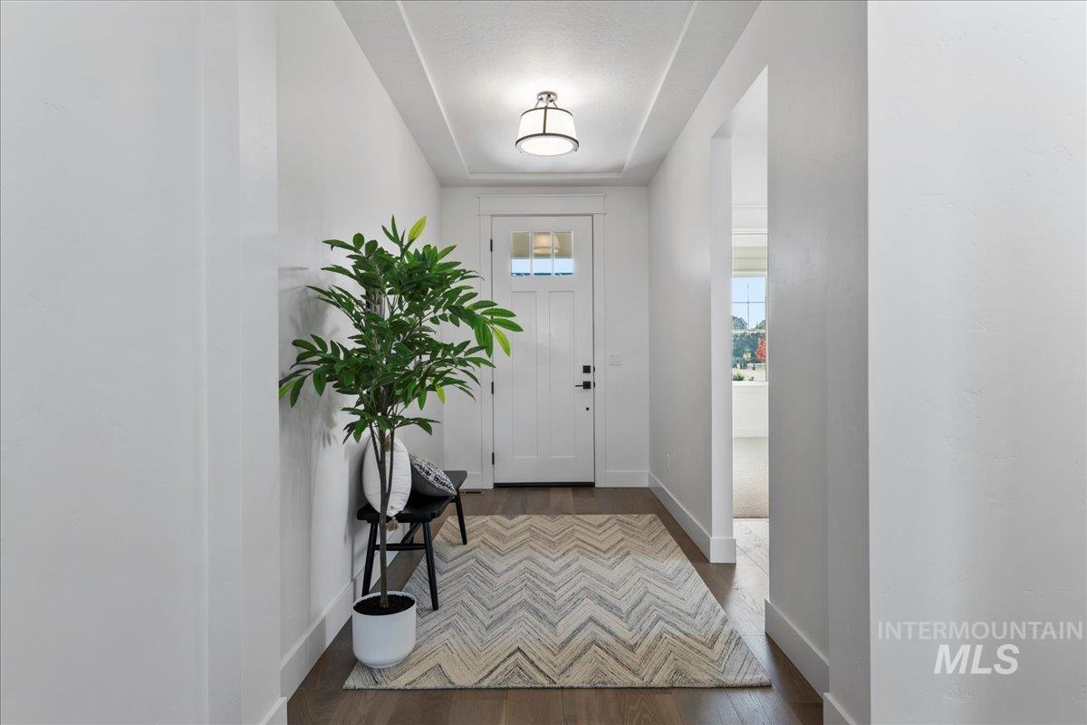 Entrance foyer with wood finished floors and baseboards