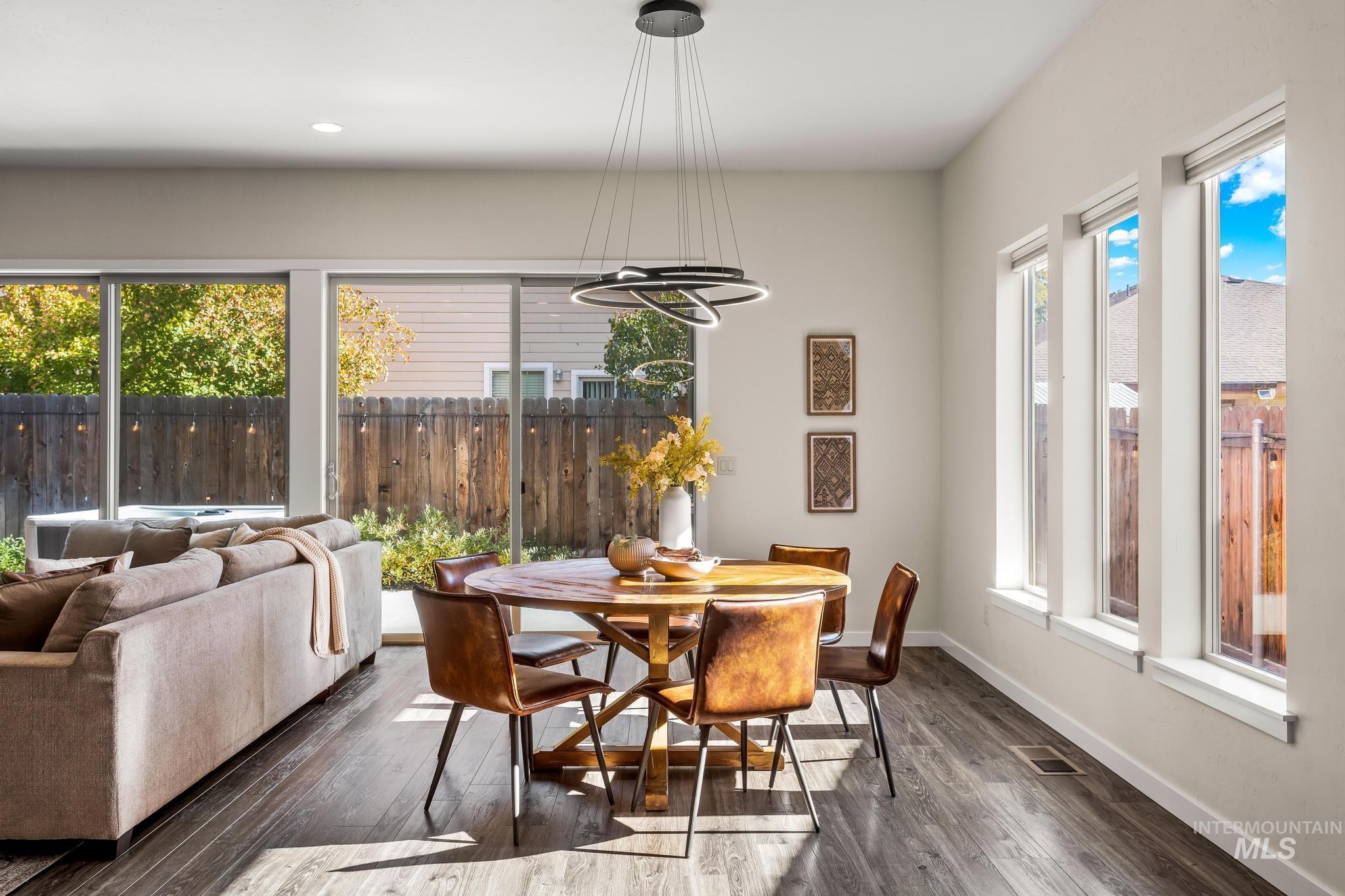 Dining room featuring dark wood-style flooring and recessed lighting