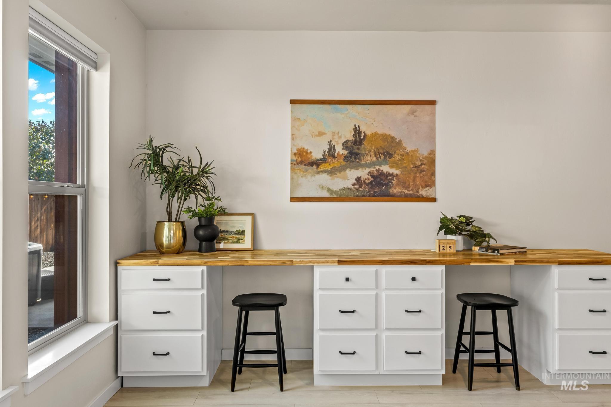 Home office featuring built in study area