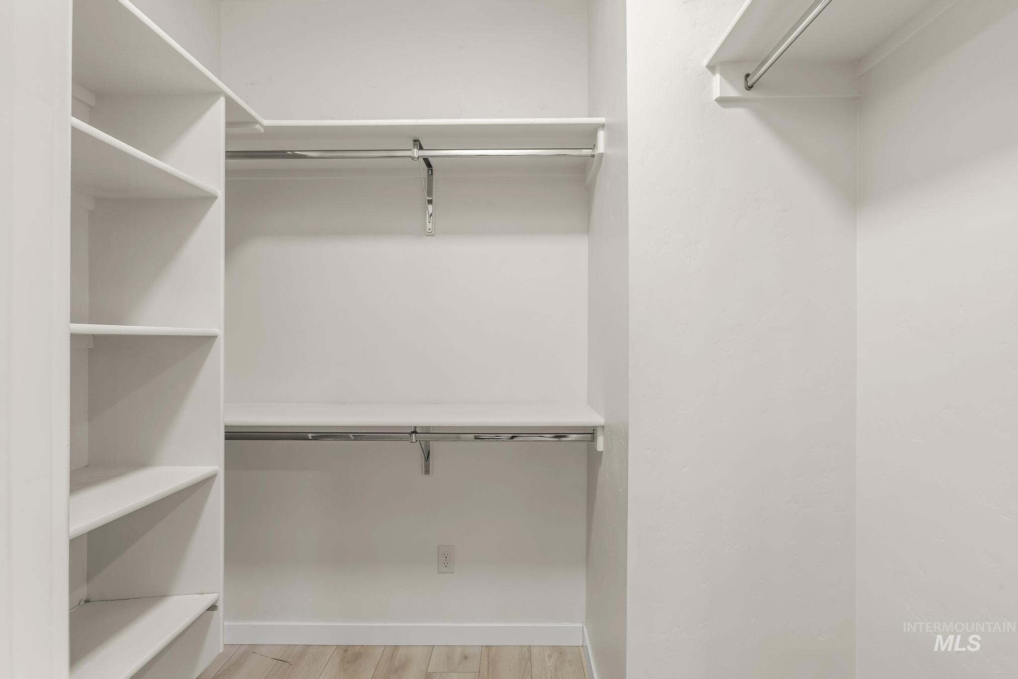 Spacious closet with light wood-type flooring