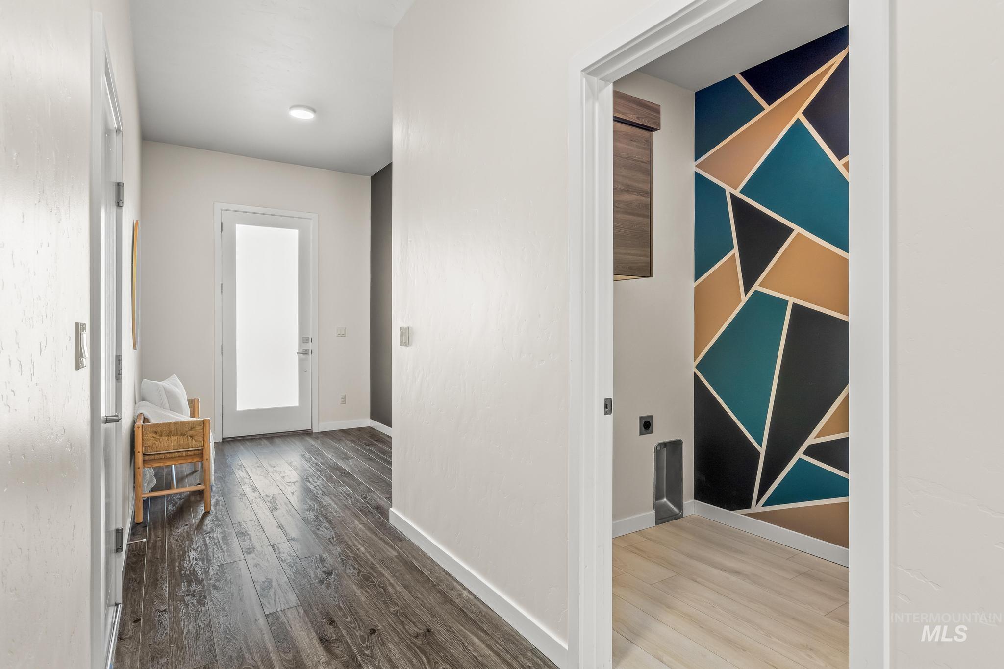 Hallway with light wood-type flooring and baseboards