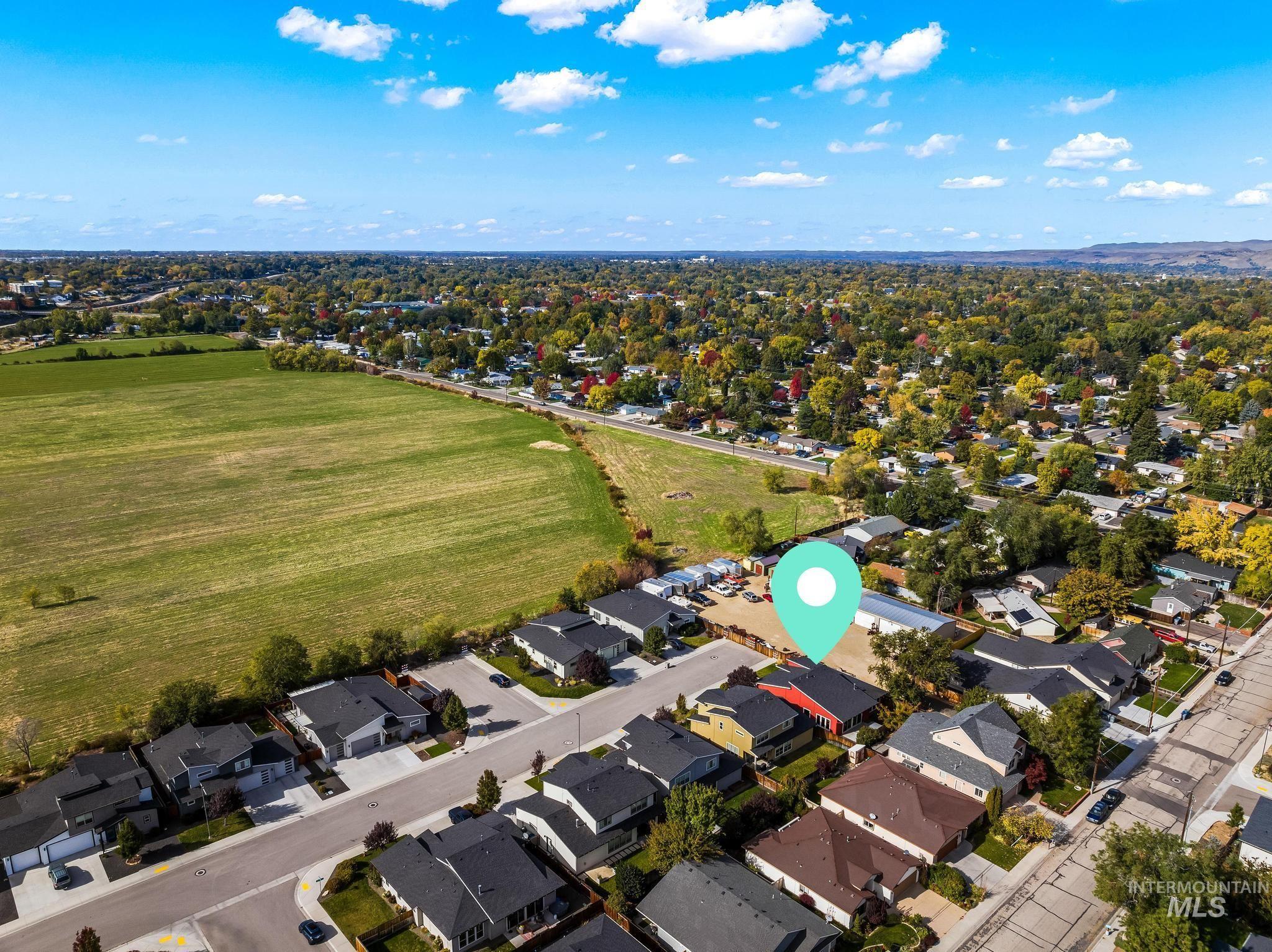 Aerial overview of property's location featuring nearby suburban area