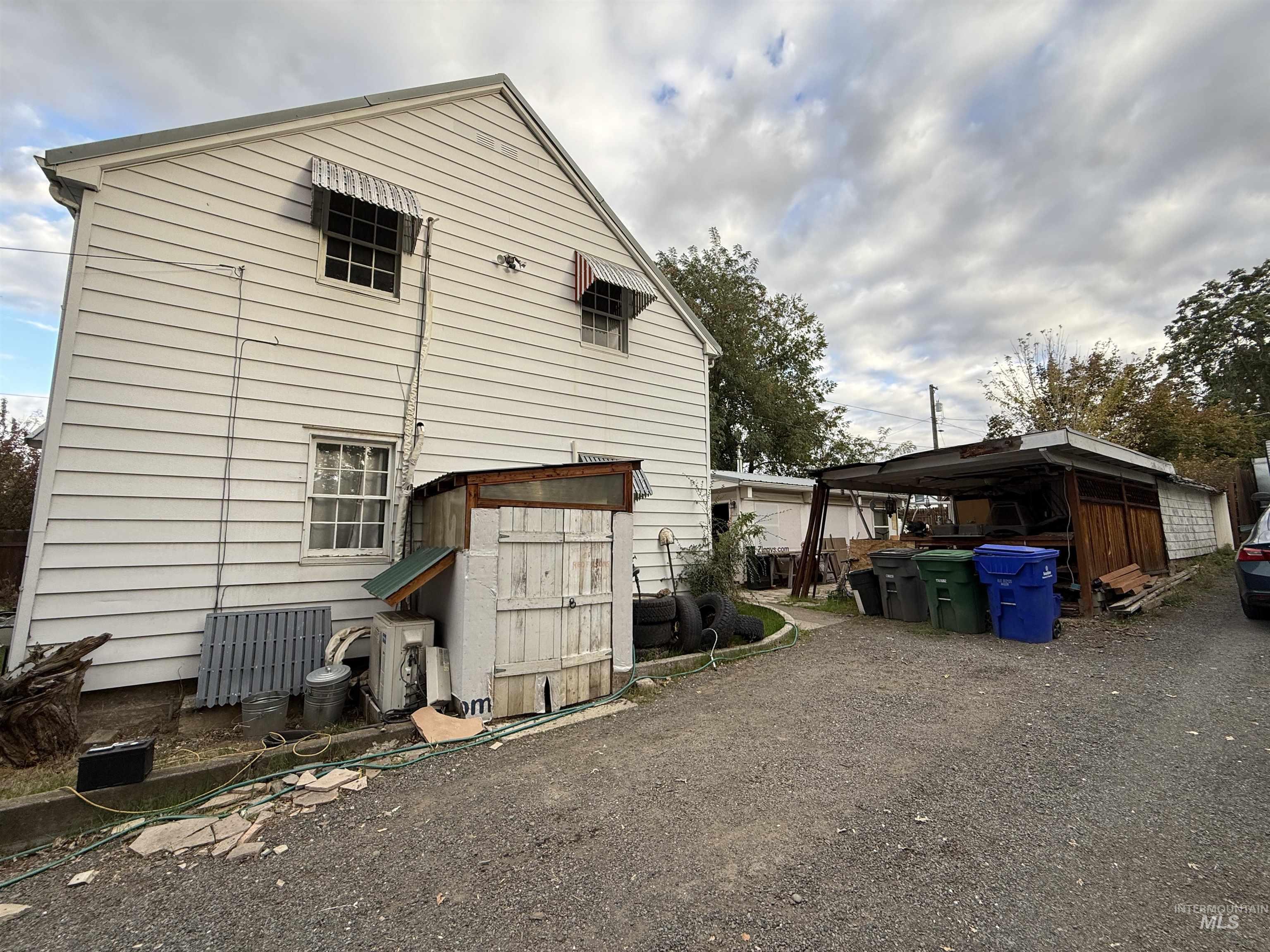 Rear view of house featuring a carport