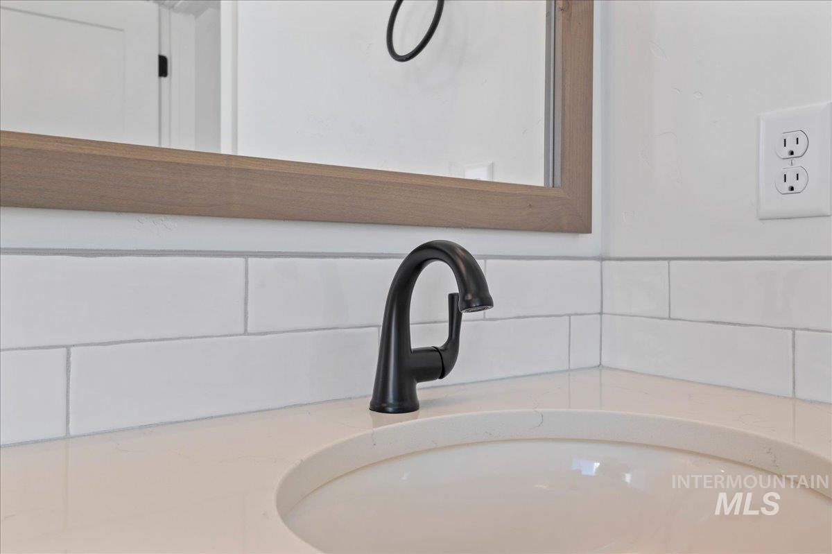 Bathroom view of vanity and decorative backsplash