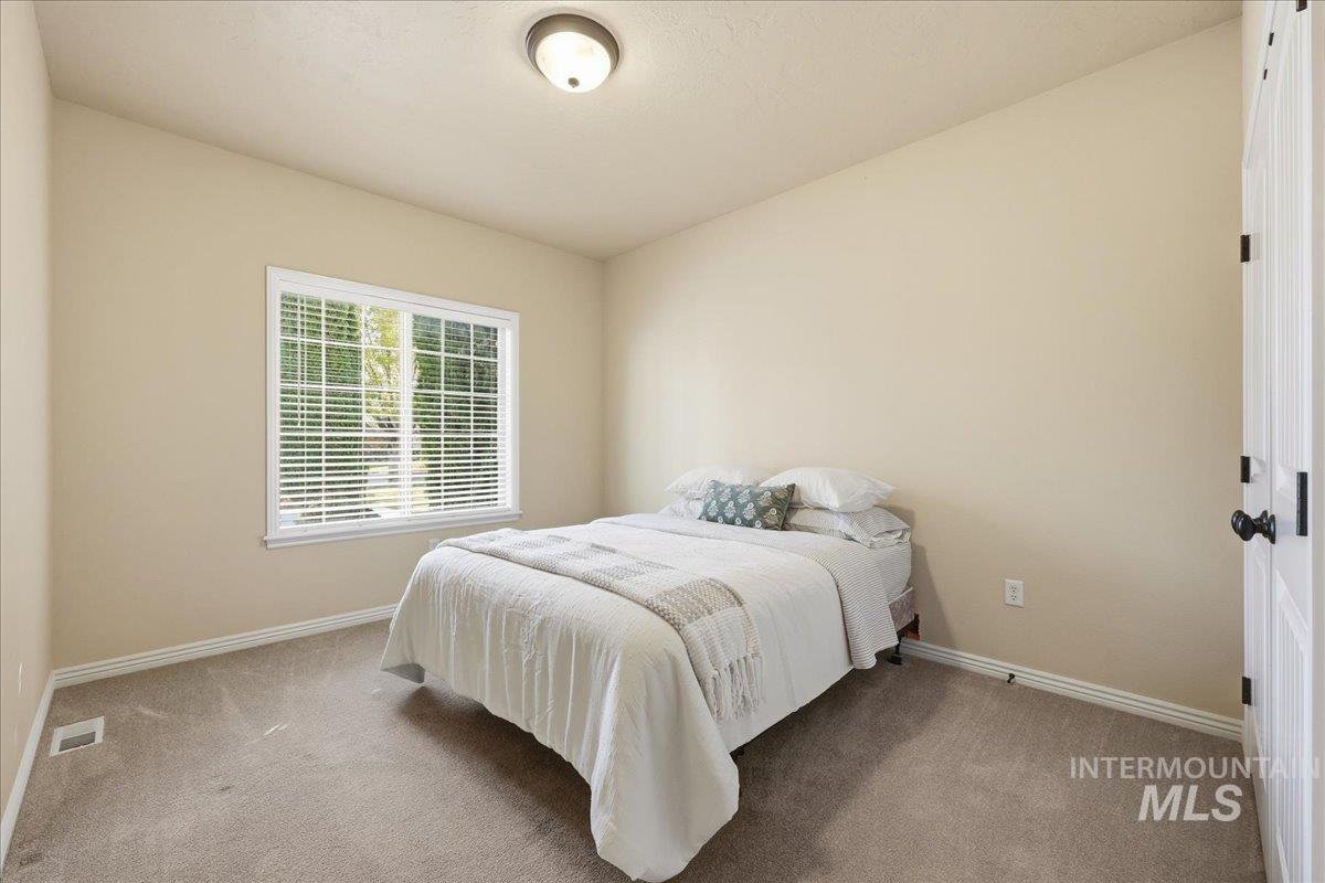 Carpeted bedroom featuring baseboards