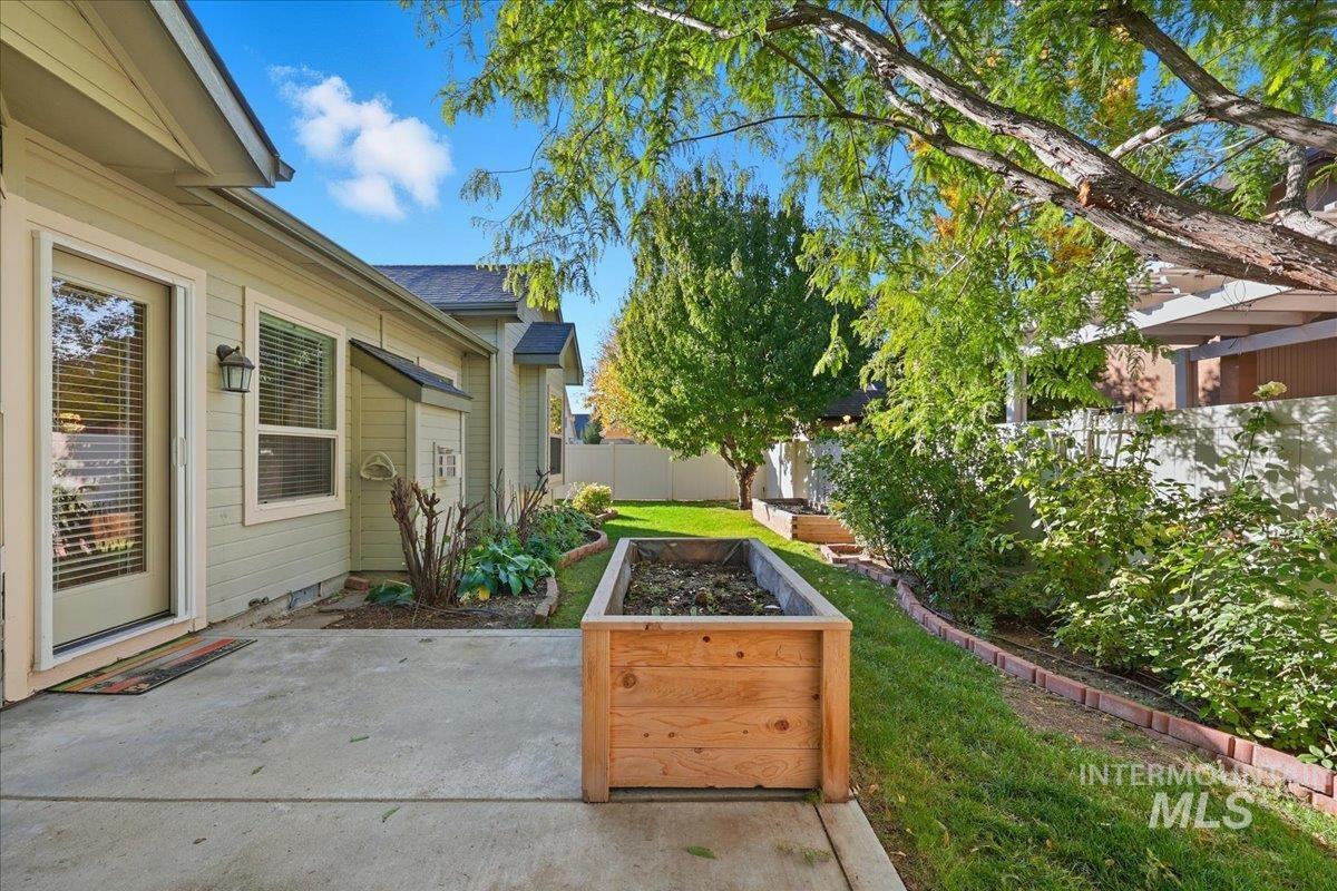 Fenced backyard featuring a patio area and a garden
