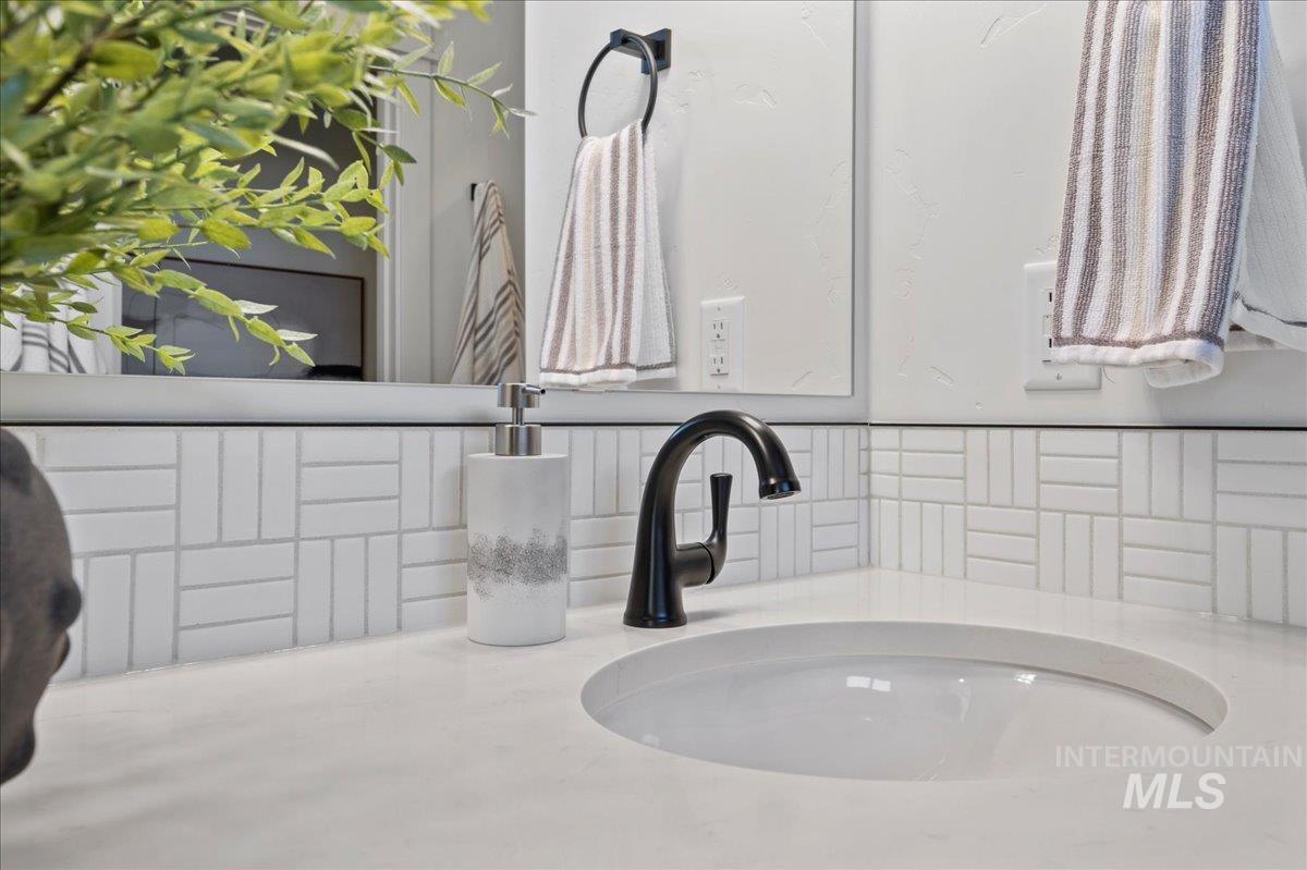 Bathroom view of tasteful backsplash and vanity