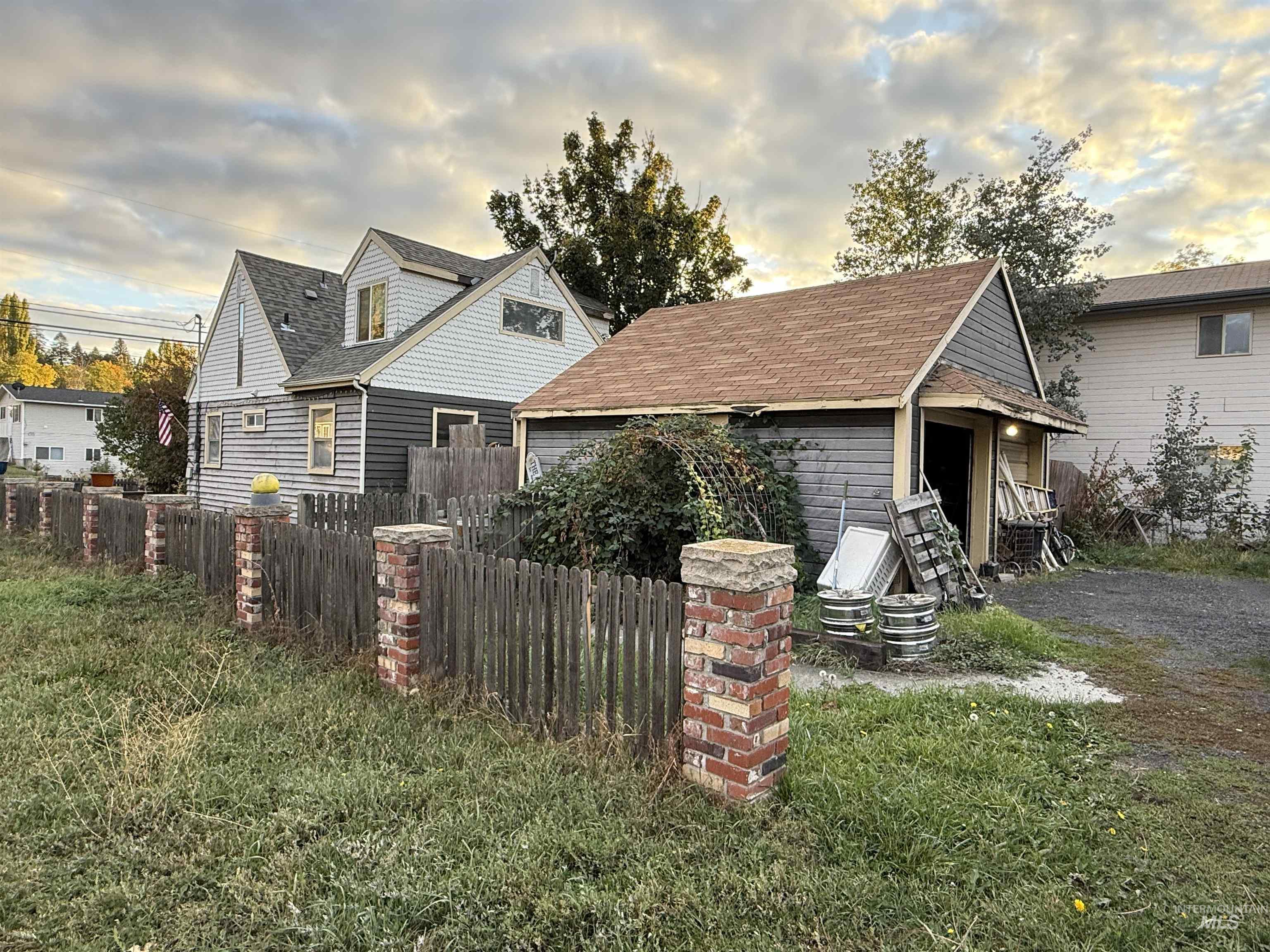 Back of house featuring a shingled roof