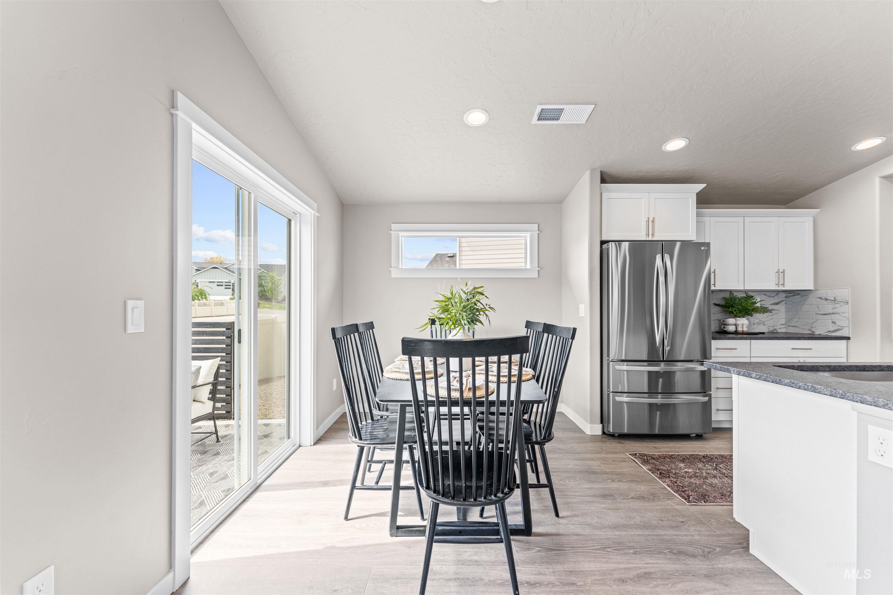 Dining space with light wood-type flooring and recessed lighting
