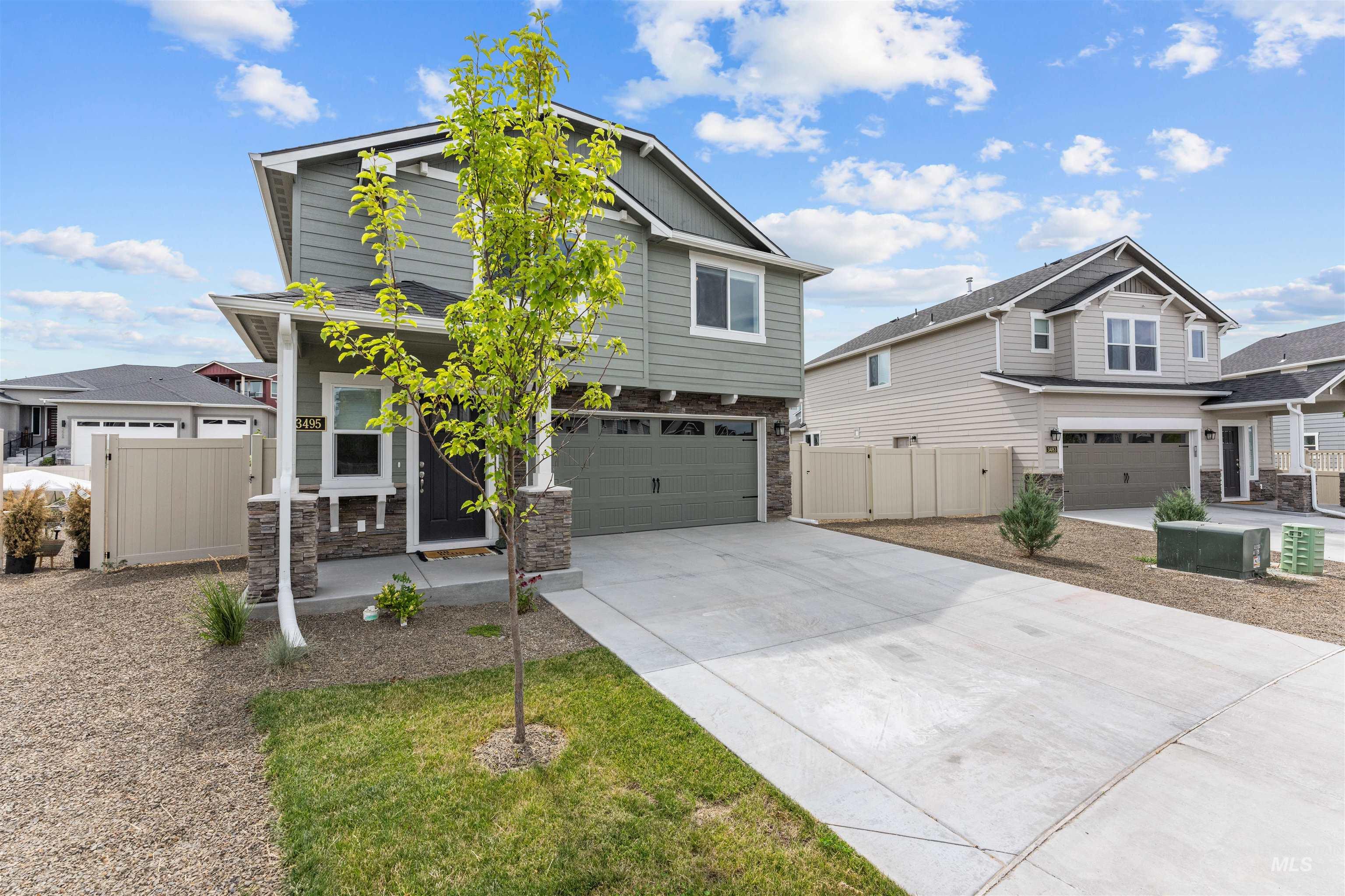Craftsman inspired home with stone siding, driveway, an attached garage, and a gate