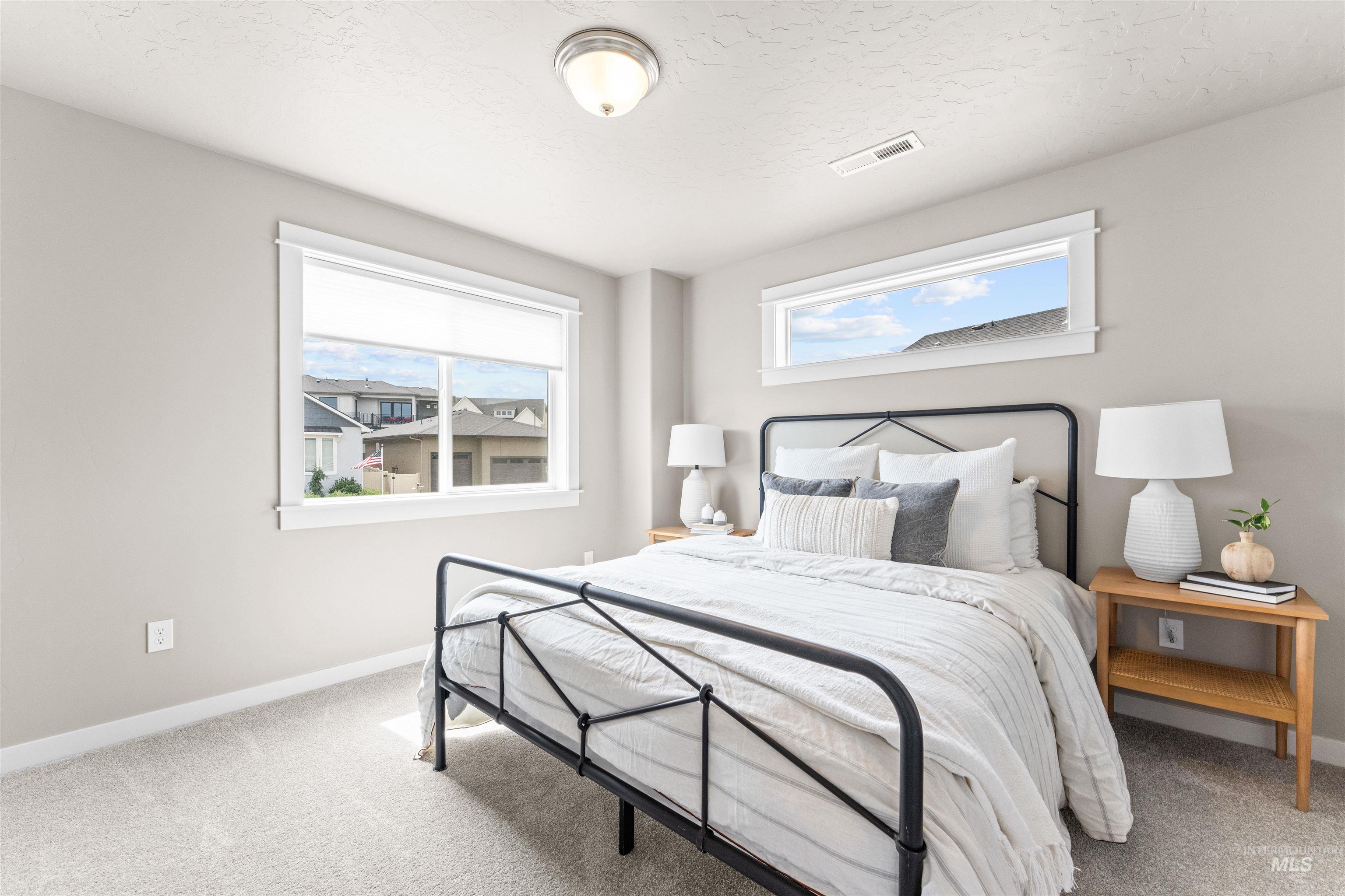 Bedroom with carpet floors and a textured ceiling