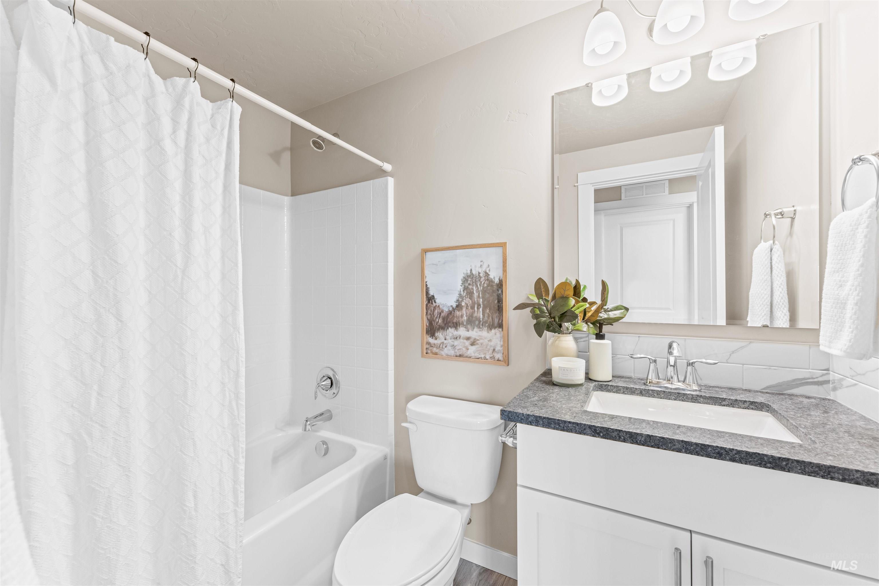 Bathroom with shower / bath combo and vanity