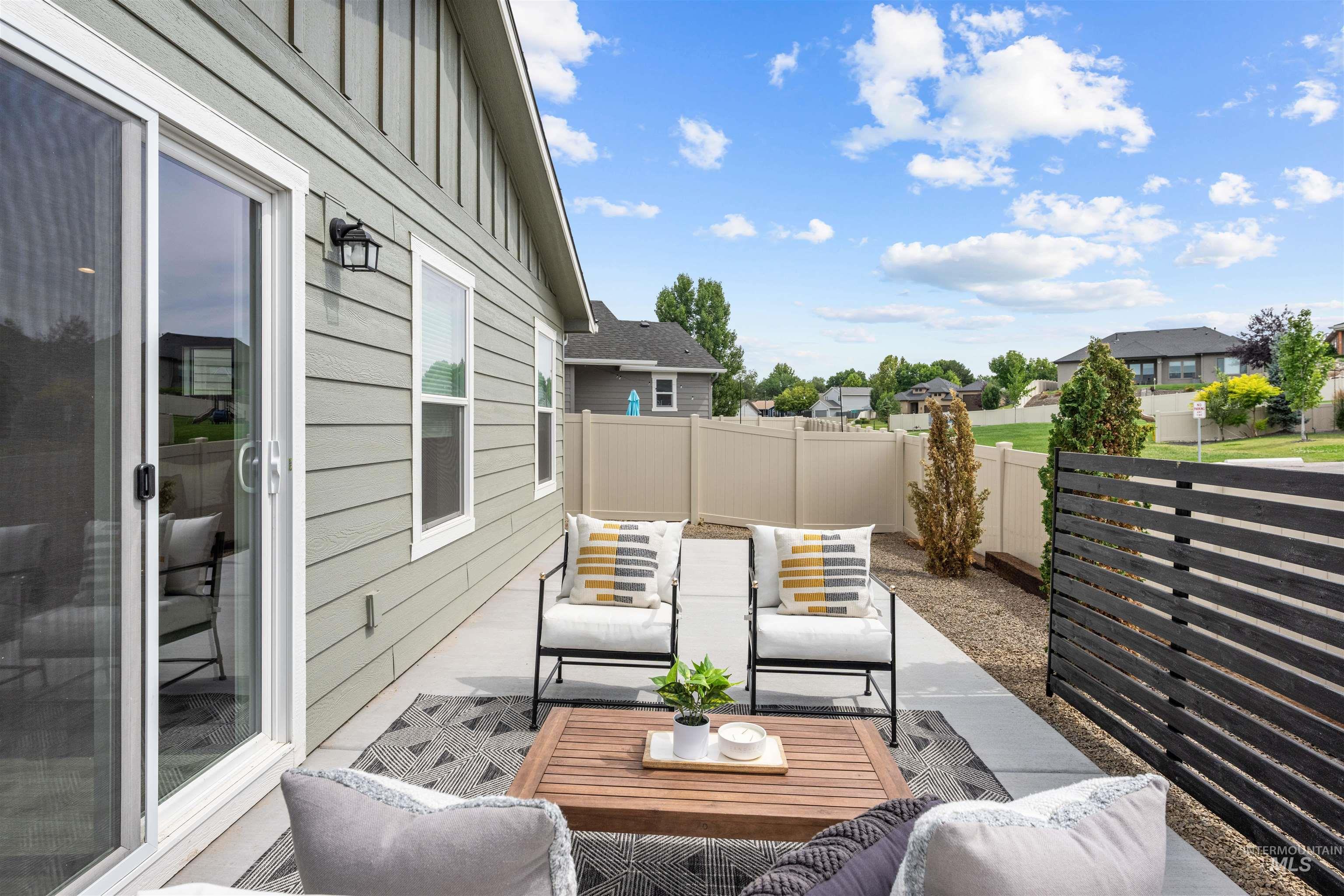 Fenced backyard with an outdoor living space, a patio area, and a residential view