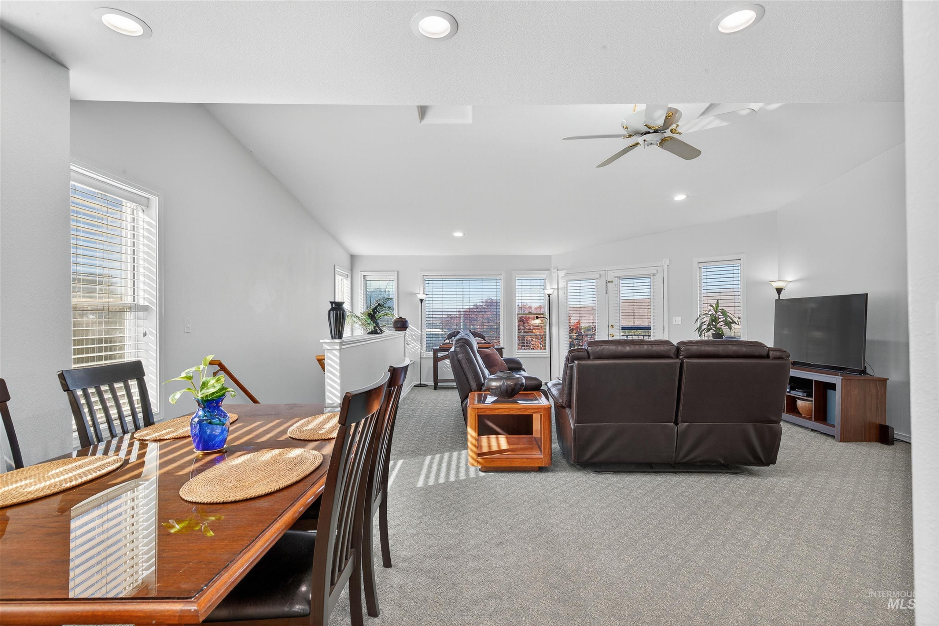 Dining space with recessed lighting, carpet, plenty of natural light, and ceiling fan