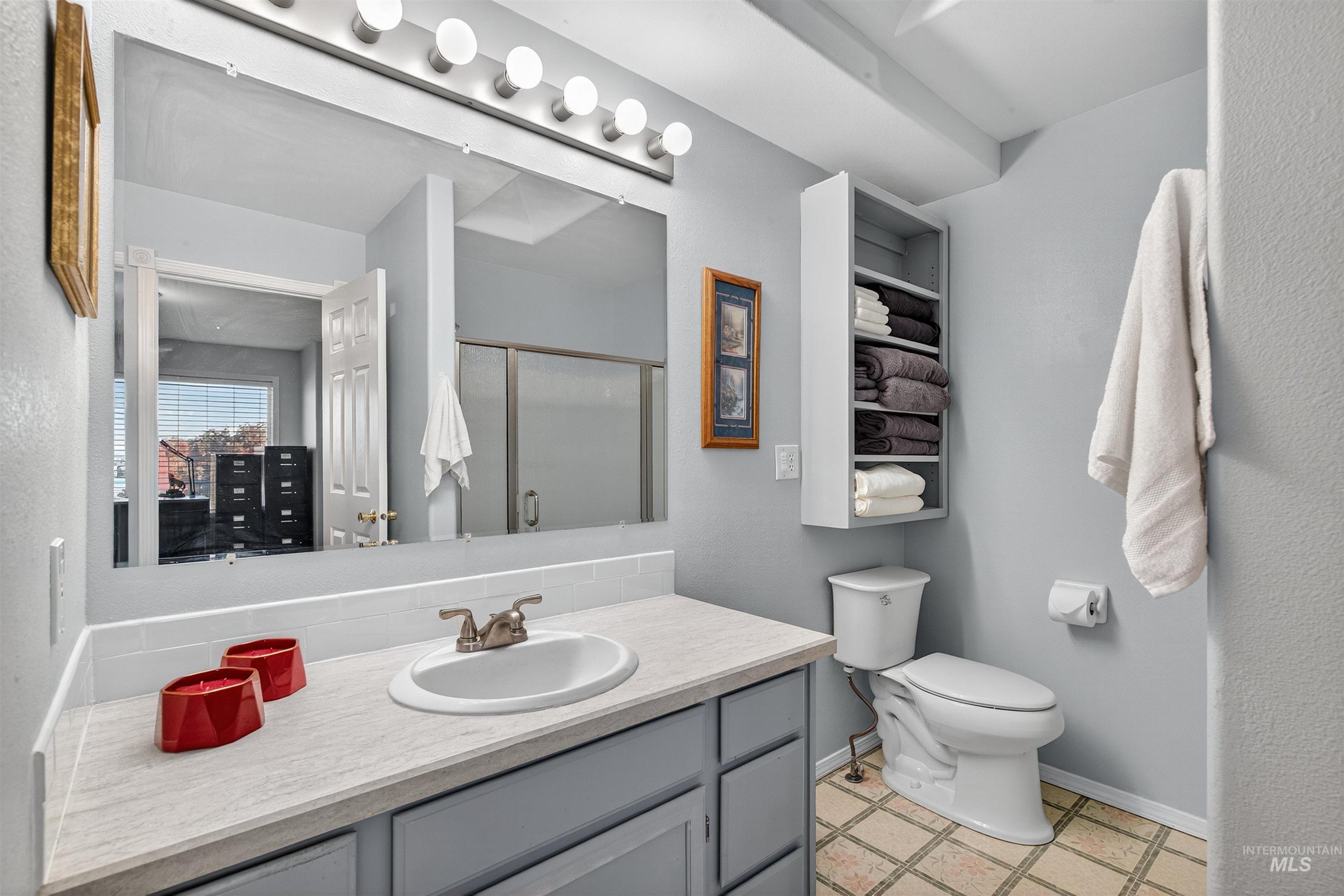 Bathroom featuring vanity and a stall shower