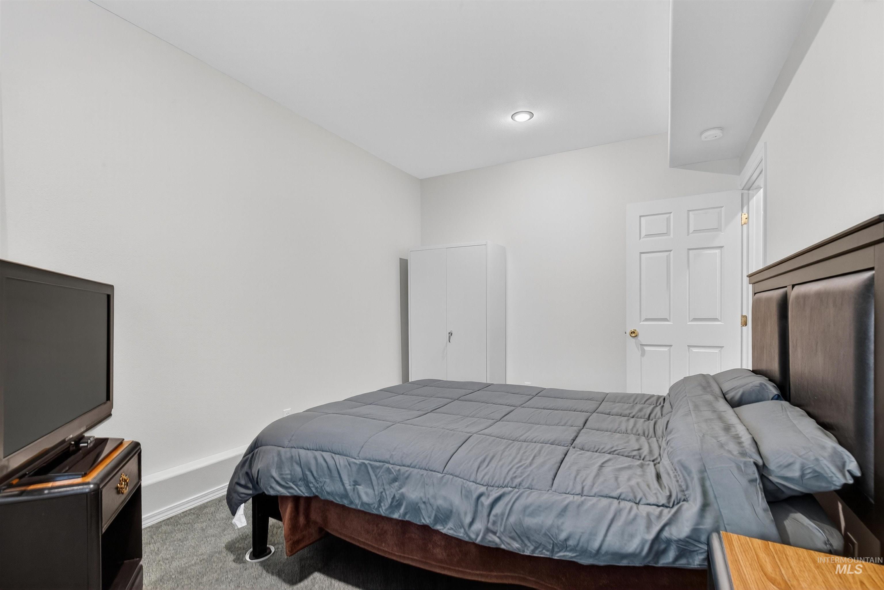 Bedroom with carpet floors and baseboards