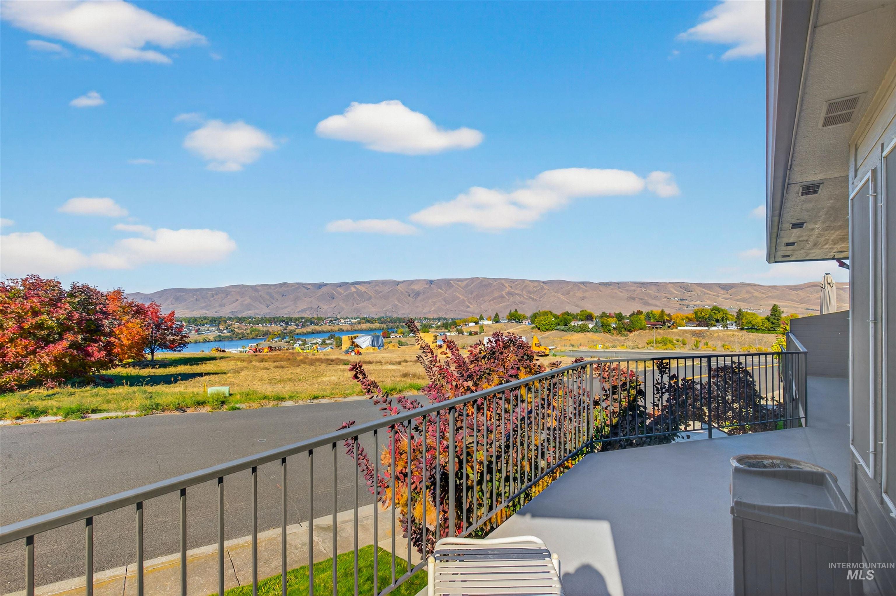Balcony with a water and mountain view