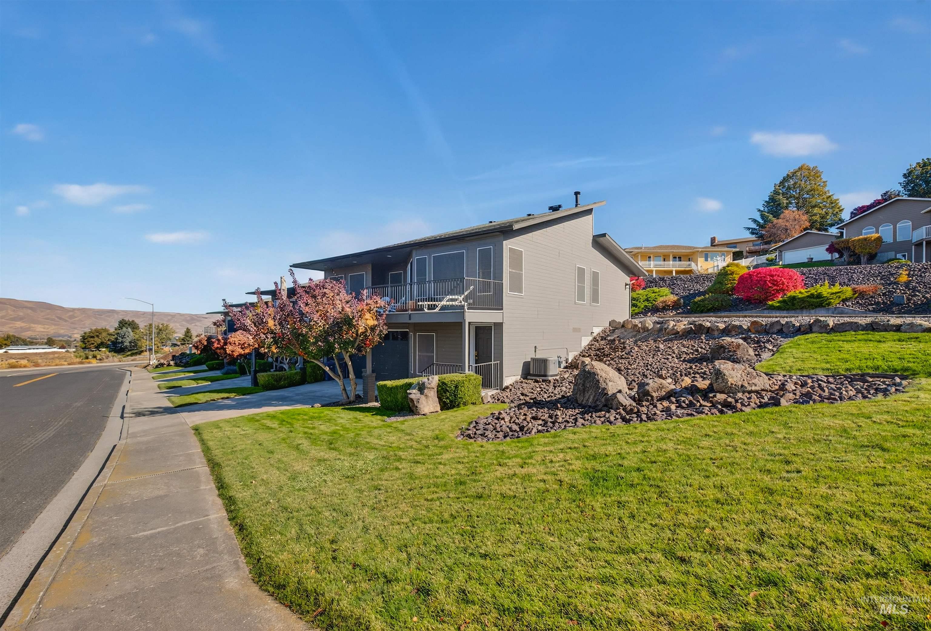 View of building exterior featuring concrete driveway and a mountain view