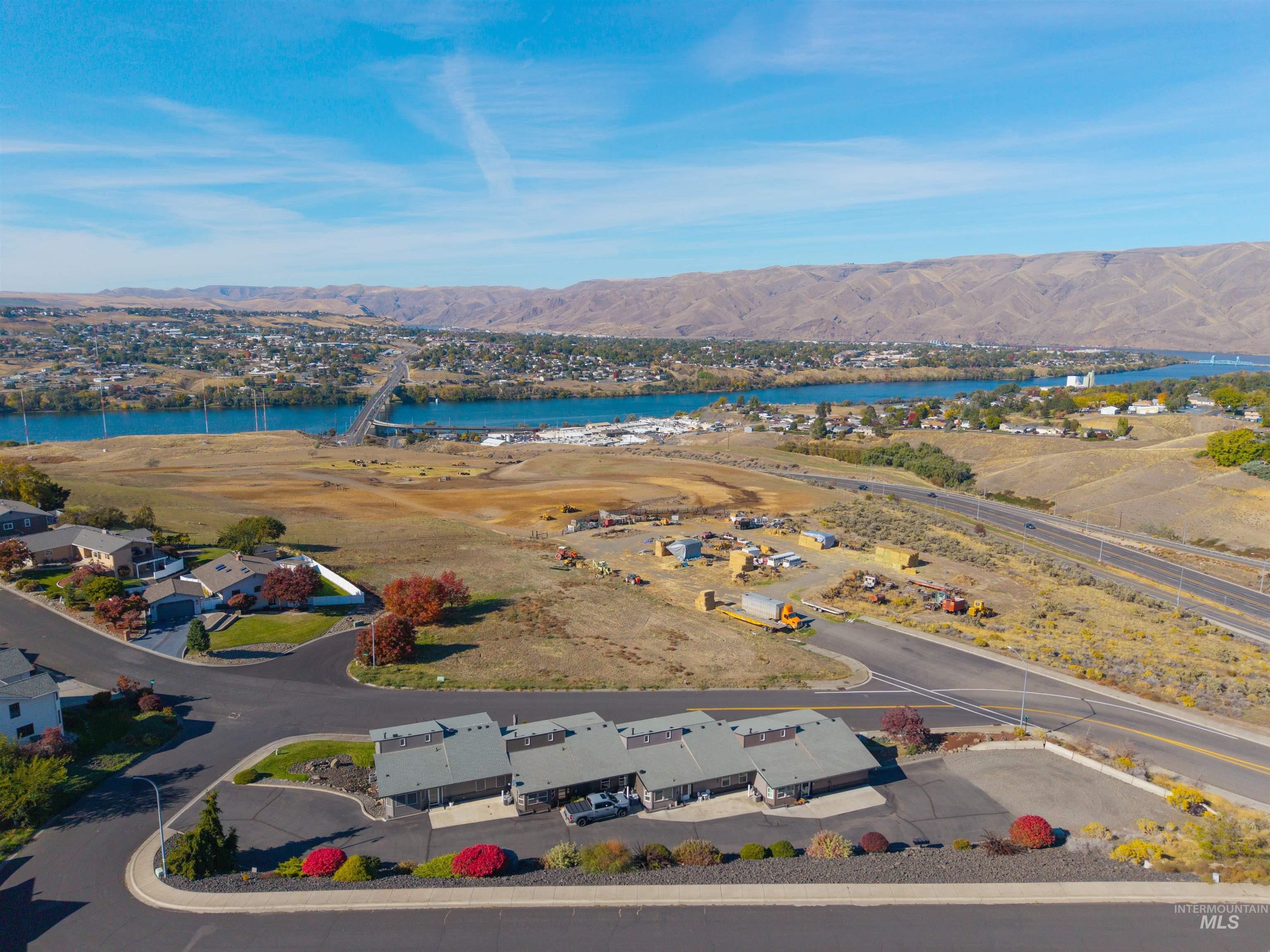 Aerial perspective of suburban area with a water and mountain view