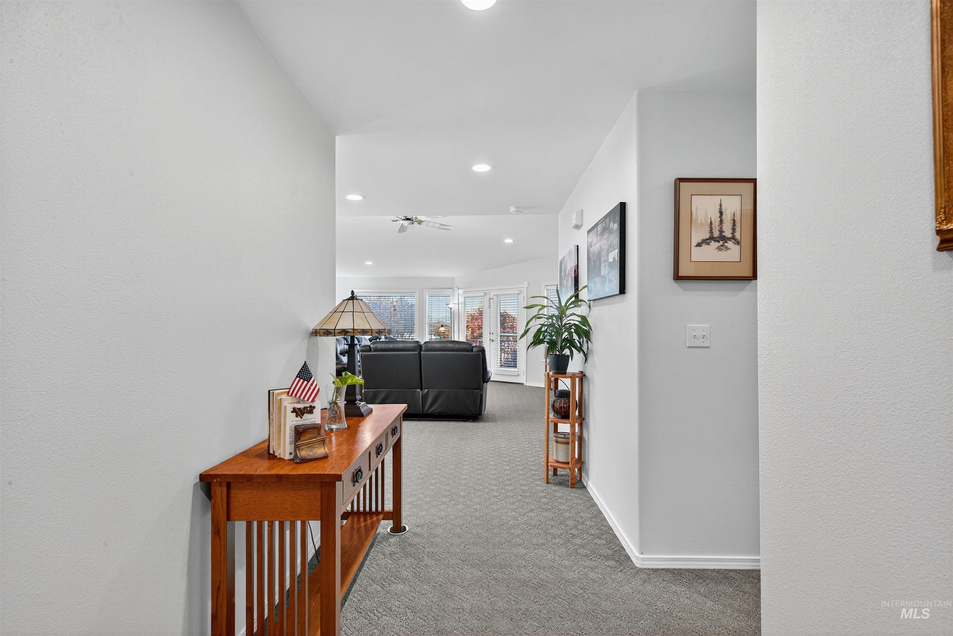 Hallway featuring light carpet and recessed lighting