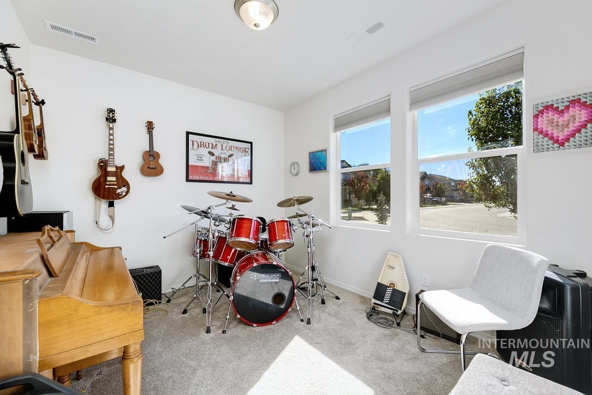 Rec room with light colored carpet and baseboards