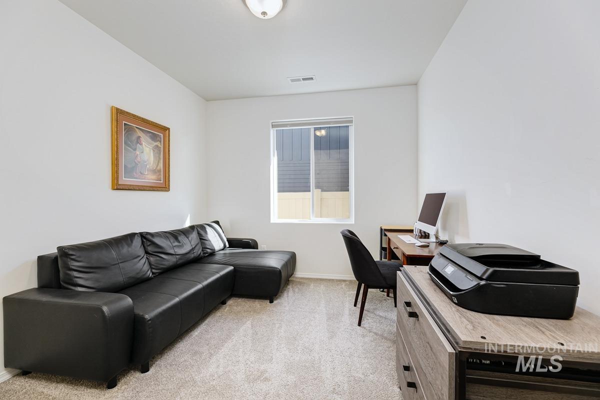 Office featuring light colored carpet and baseboards