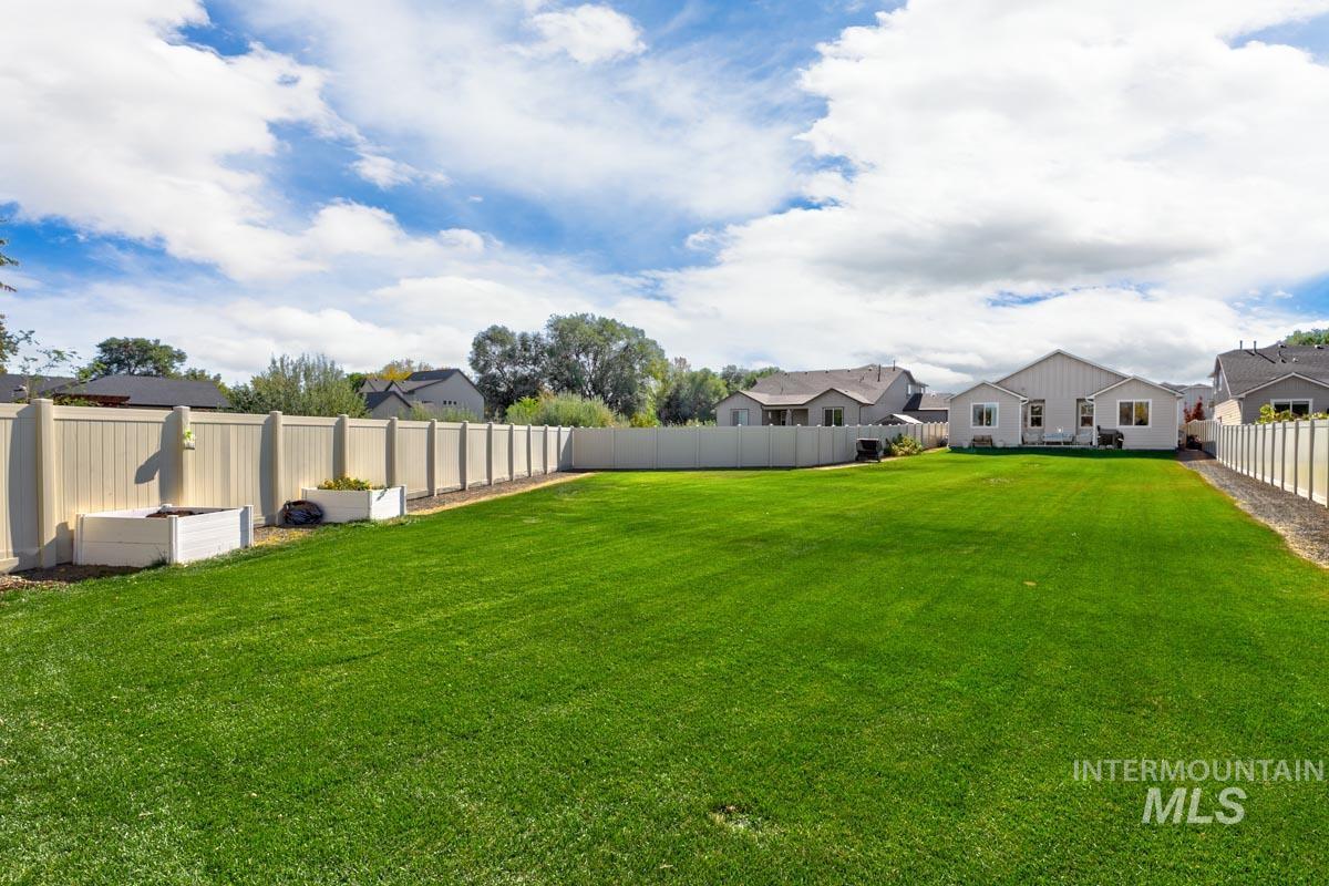 Fenced backyard featuring a residential view