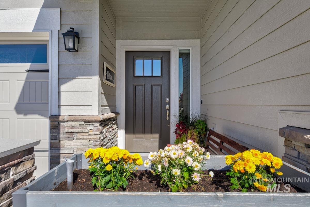 Doorway to property featuring stone siding