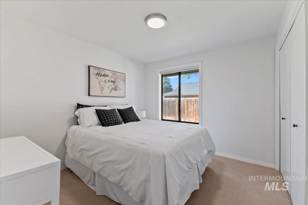 Bedroom featuring light colored carpet and a closet
