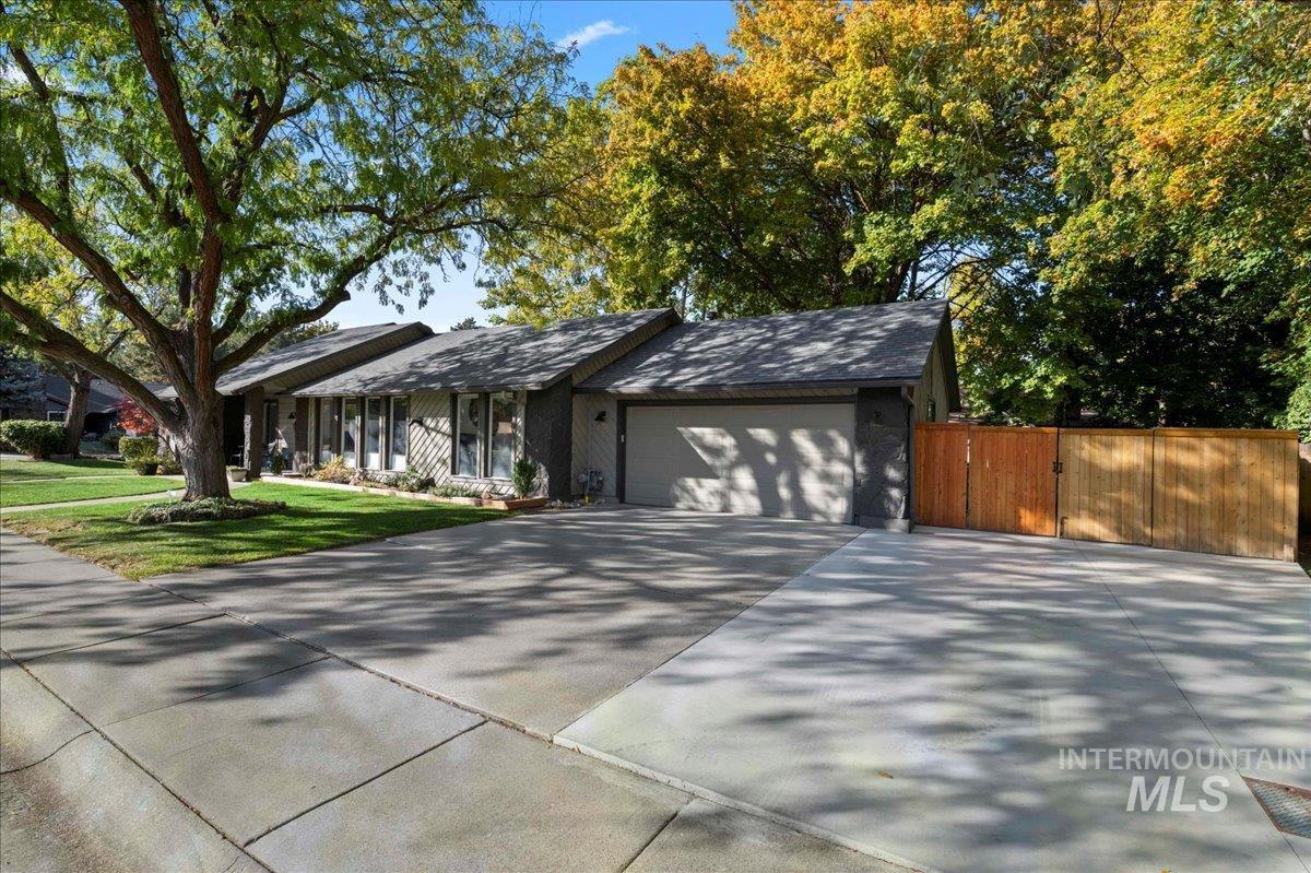 View of front of home featuring concrete driveway and a garage