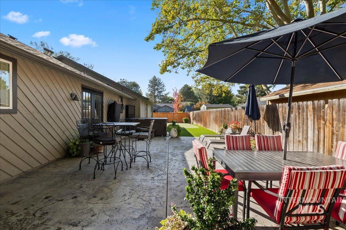 Fenced backyard with outdoor dining space and a patio area