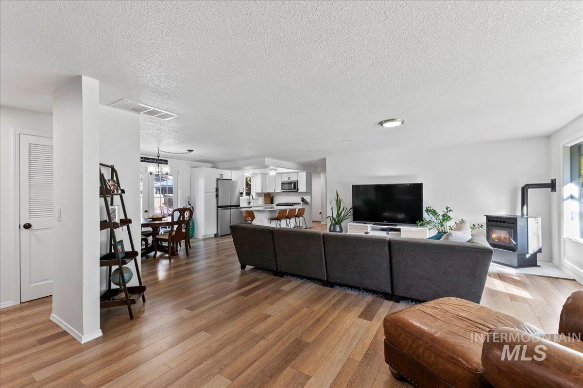 Living area with light wood finished floors and a textured ceiling