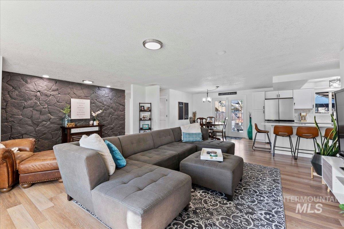 Living area with light wood-style flooring and a textured ceiling