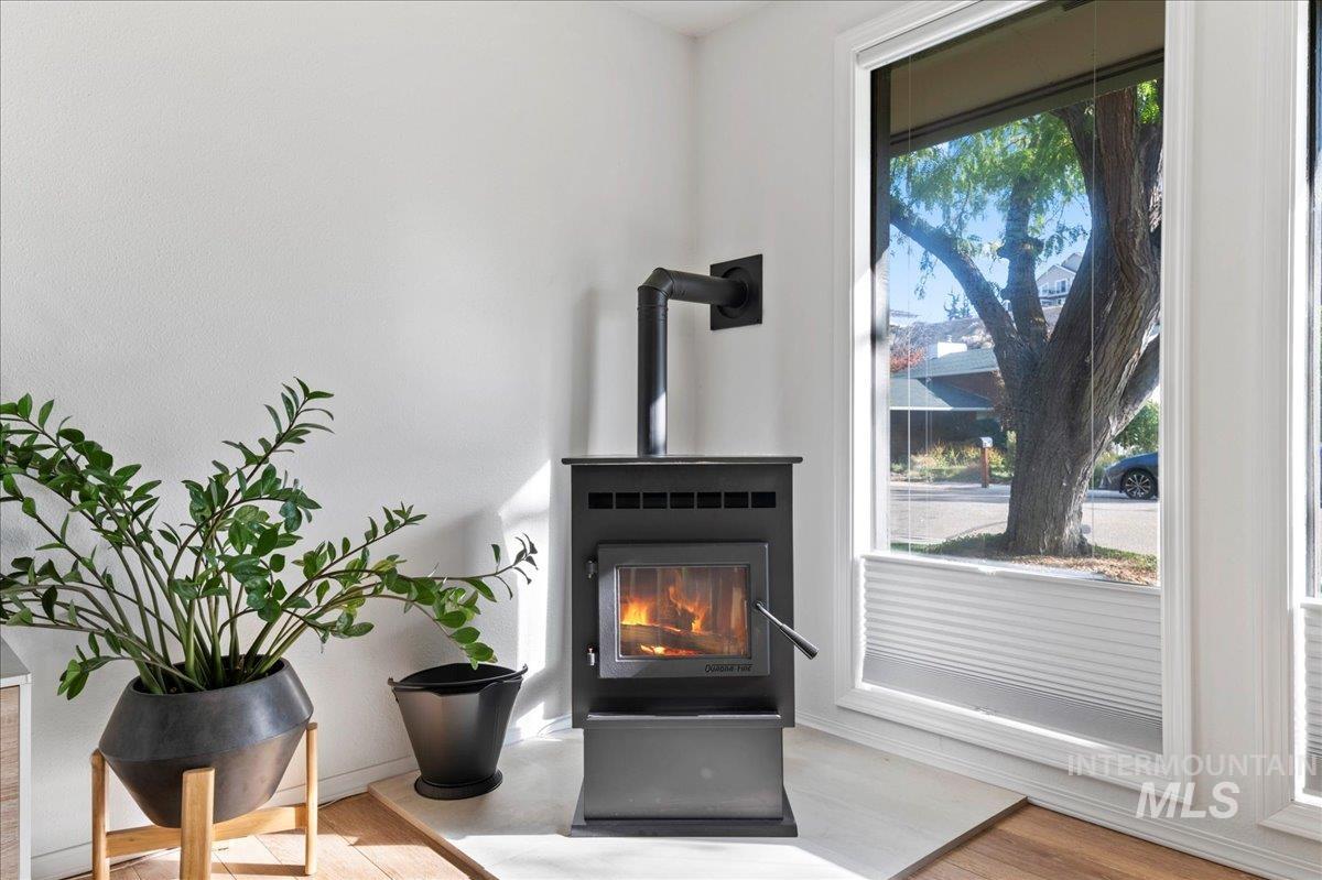 Detailed view of wood finished floors and a wood stove