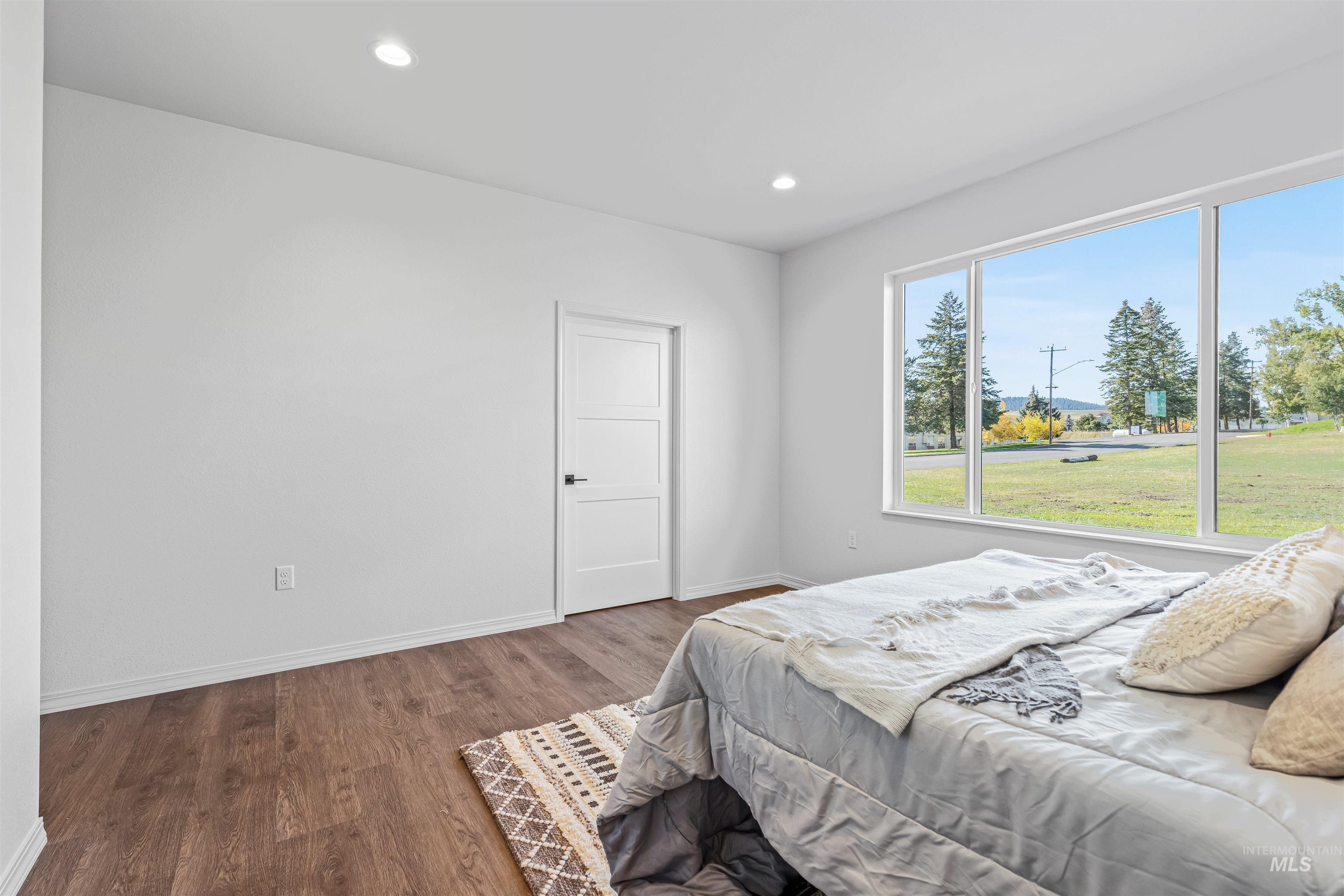 Bedroom featuring wood finished floors and recessed lighting