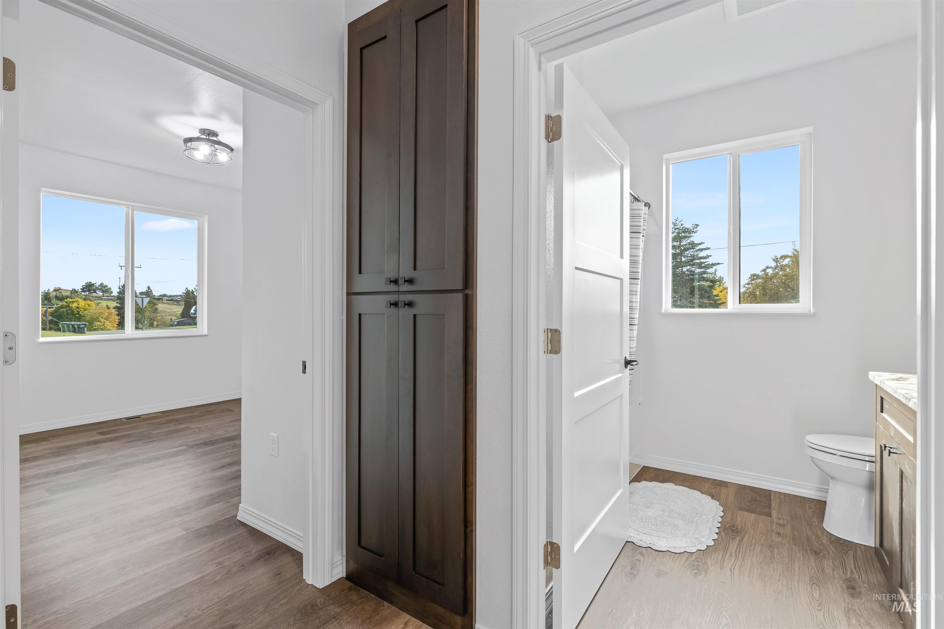 Bathroom with light wood-style flooring and vanity