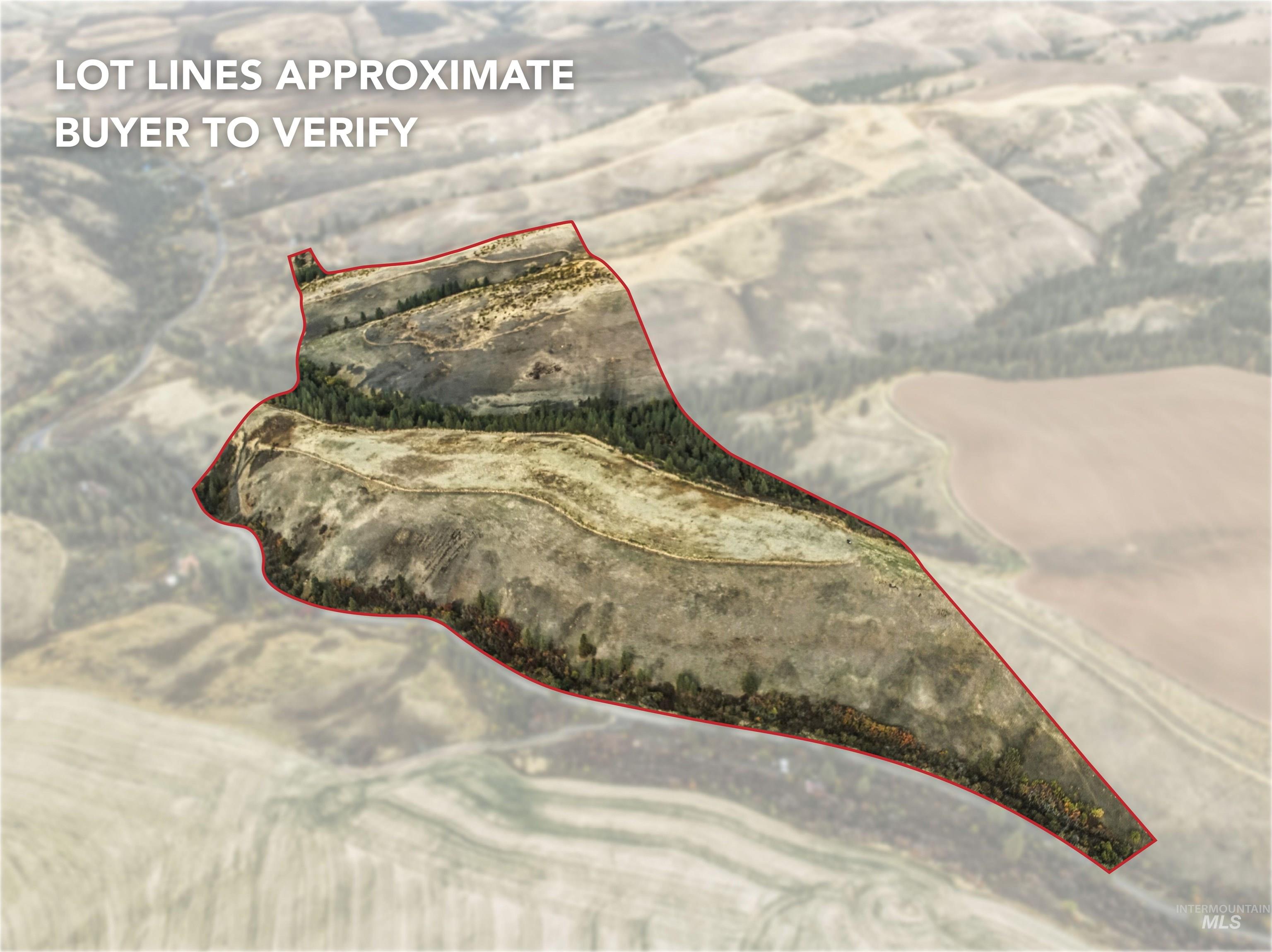 Aerial view of property and surrounding area with property parcel outlined