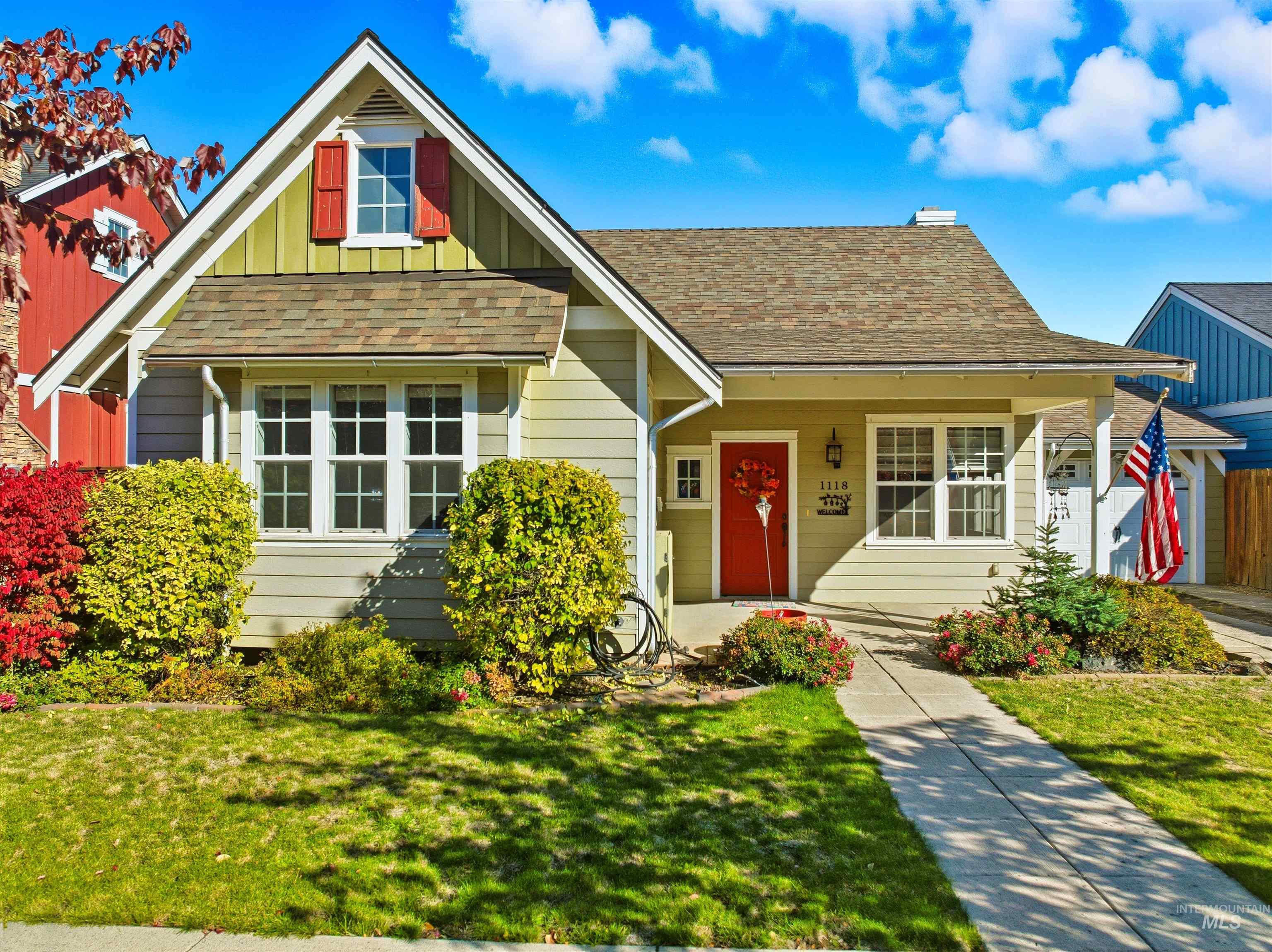 View of front of property with board and batten siding, covered porch, and roof with shingles