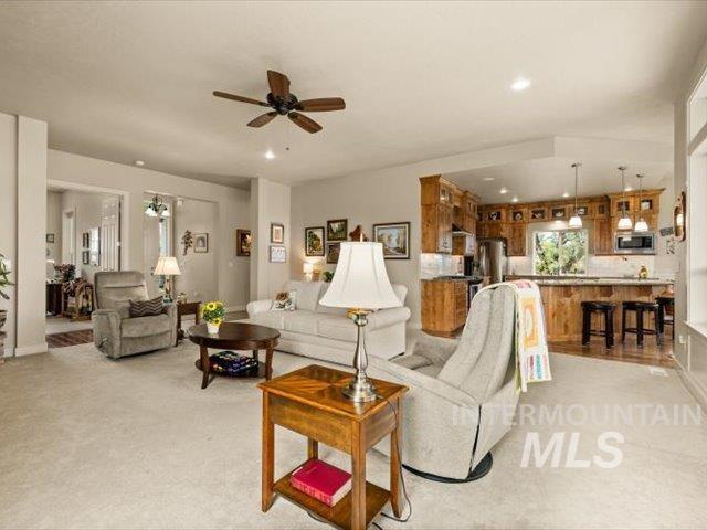 Living area with ceiling fan and recessed lighting