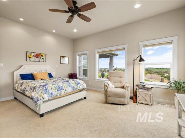 Carpeted bedroom with recessed lighting and ceiling fan