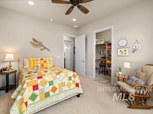 Bedroom featuring light colored carpet, ceiling fan, and recessed lighting
