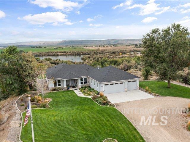 Aerial view of property and surrounding area with a nearby body of water