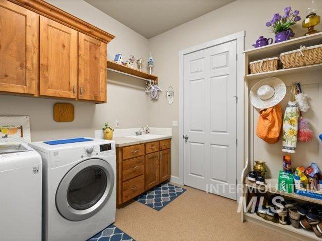 Laundry room featuring washing machine and dryer and cabinet space