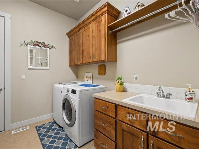 Laundry area featuring washing machine and dryer and cabinet space