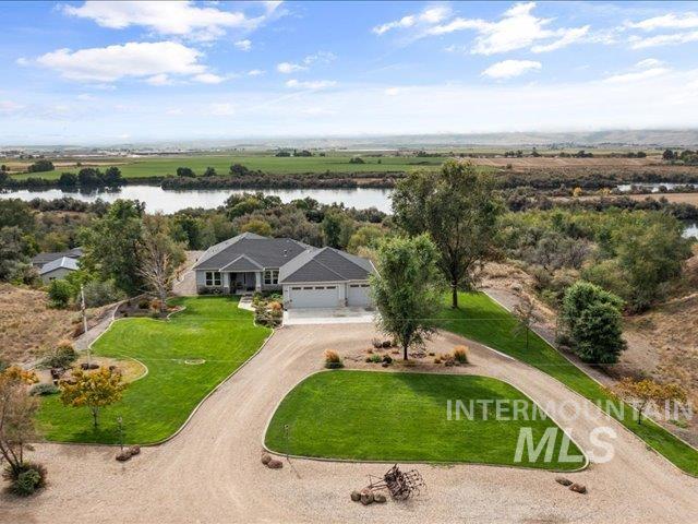 Aerial view of property and surrounding area with a large body of water