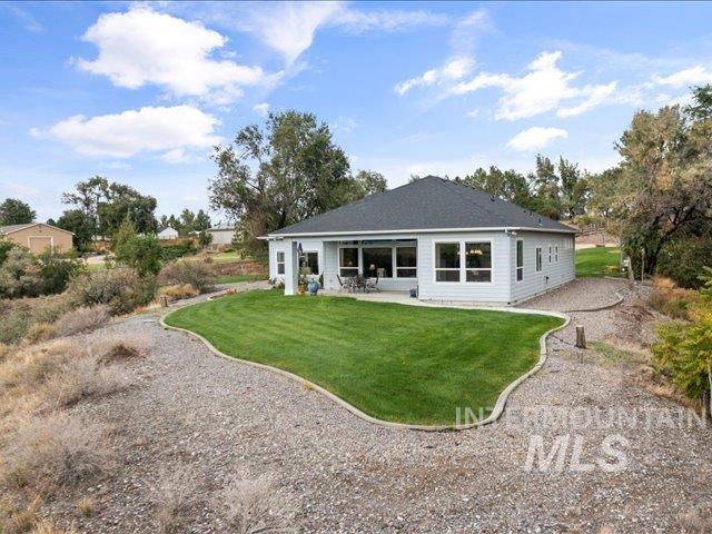 Rear view of property featuring a patio and a yard