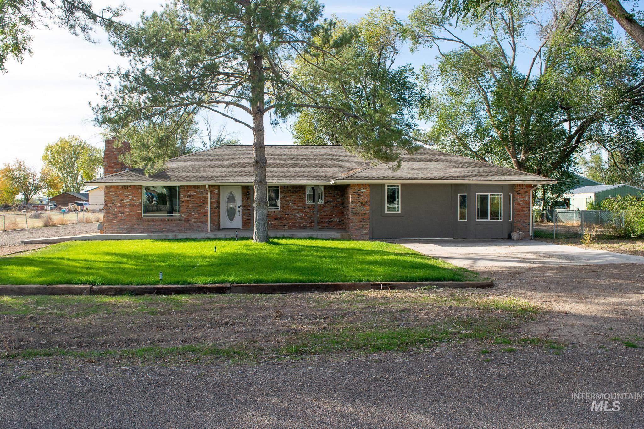 Ranch-style home with brick siding and roof with shingles